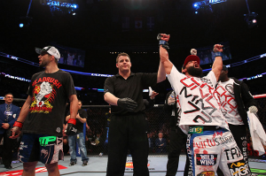 Johny Hendricks (right) celebrates his victory over Carlos Condit (left) at UFC 158. (Photo: UFC.com)