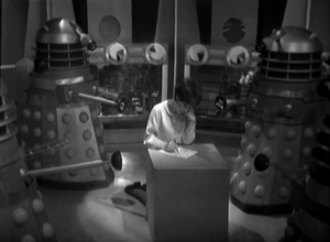 The daleks bully Susan as they dictate a note