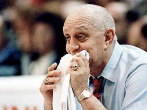 Jerry Tarkanian biting on his trademark towel as he coaches his team.